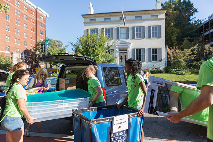 students assisting in move in carrying in belongings to thurston hall