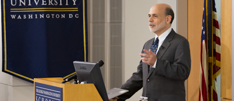 Ben Bernanke at podium in front of classroom speaking to students