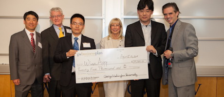 Winners of GW Business Plan Competition WiseApp smile with oversized $25,000 check marking their win