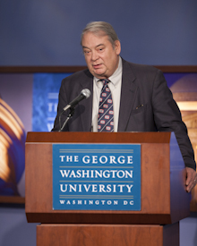 Ferid Murad at podium with a The George Washington University plaque on it