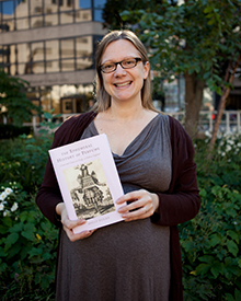 Holly Dugan holds book and smiles, book is "The Ephemeral History of Perfume: Scent and Sense in Early Modern England.”