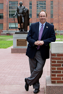 Jim Core in University Yard with George Washington statue behind him