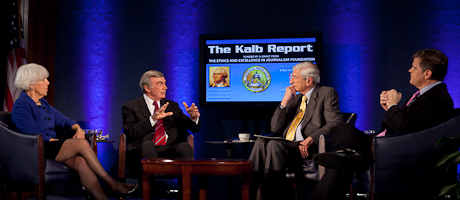 Kalb Report set with panelists sitting on stage on chairs