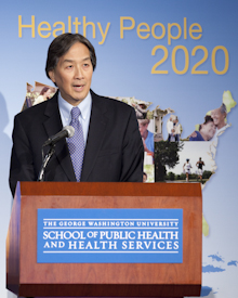  Howard K. Koh speaks a podium with the plaque The George Washington University School of Public Health and Health Sciences