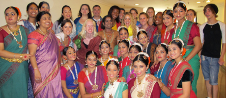 group of smiling dancers in traditional Indian attire 