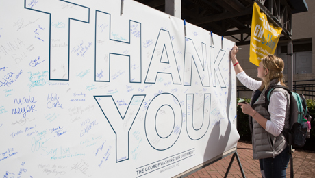 Student signs philanthropy thank-you banner