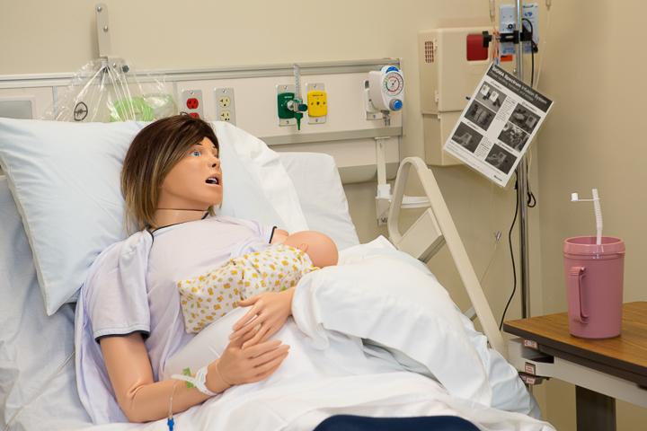 mannequin with baby in hospital bed