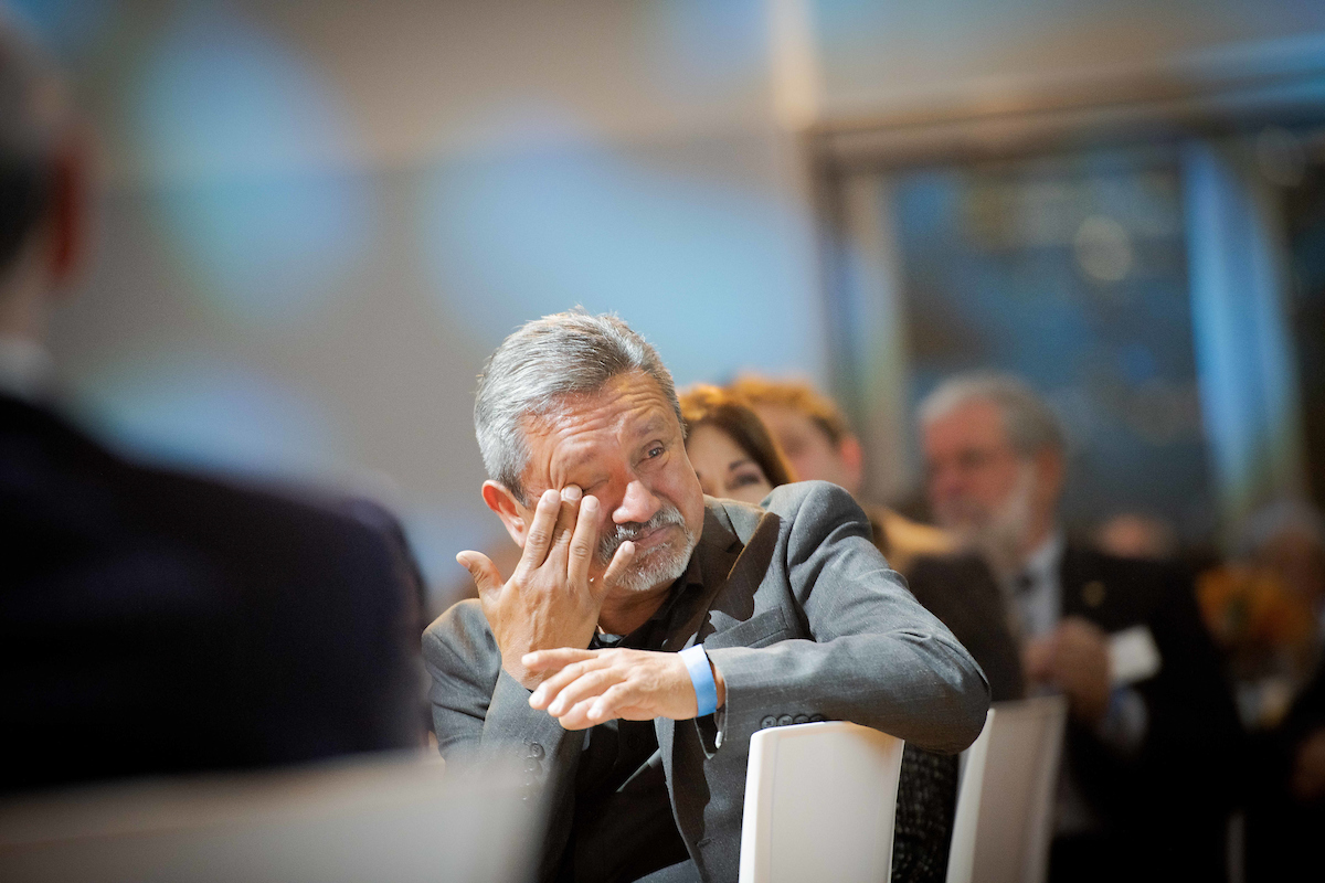 Emotional man at table in audience