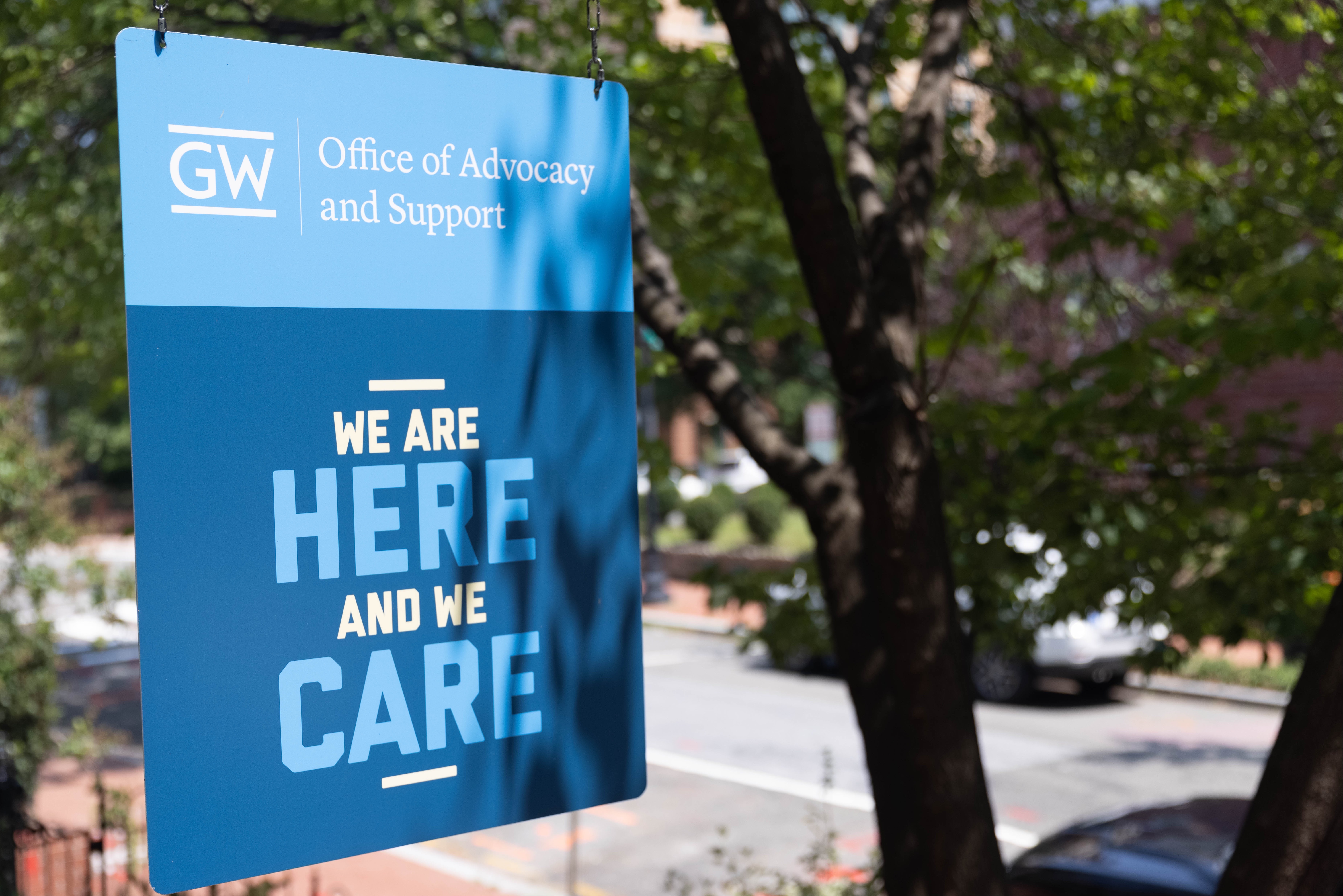 Sign outside OAS office reading "We are here and we care"