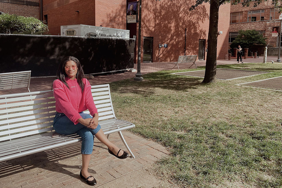 Zeniya Cooley sitting on a park bench