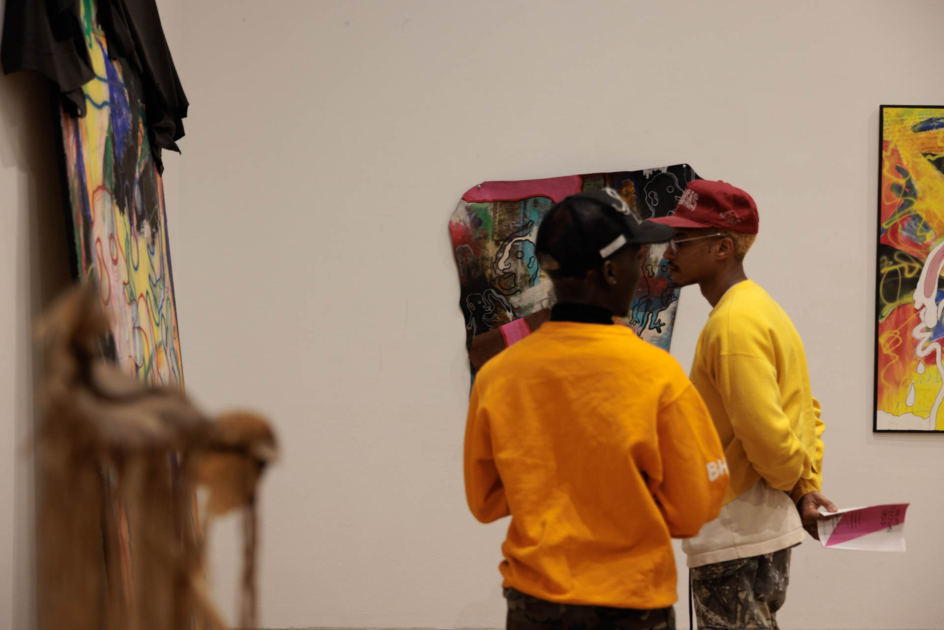 Two viewers admire art exhibit at NEXT