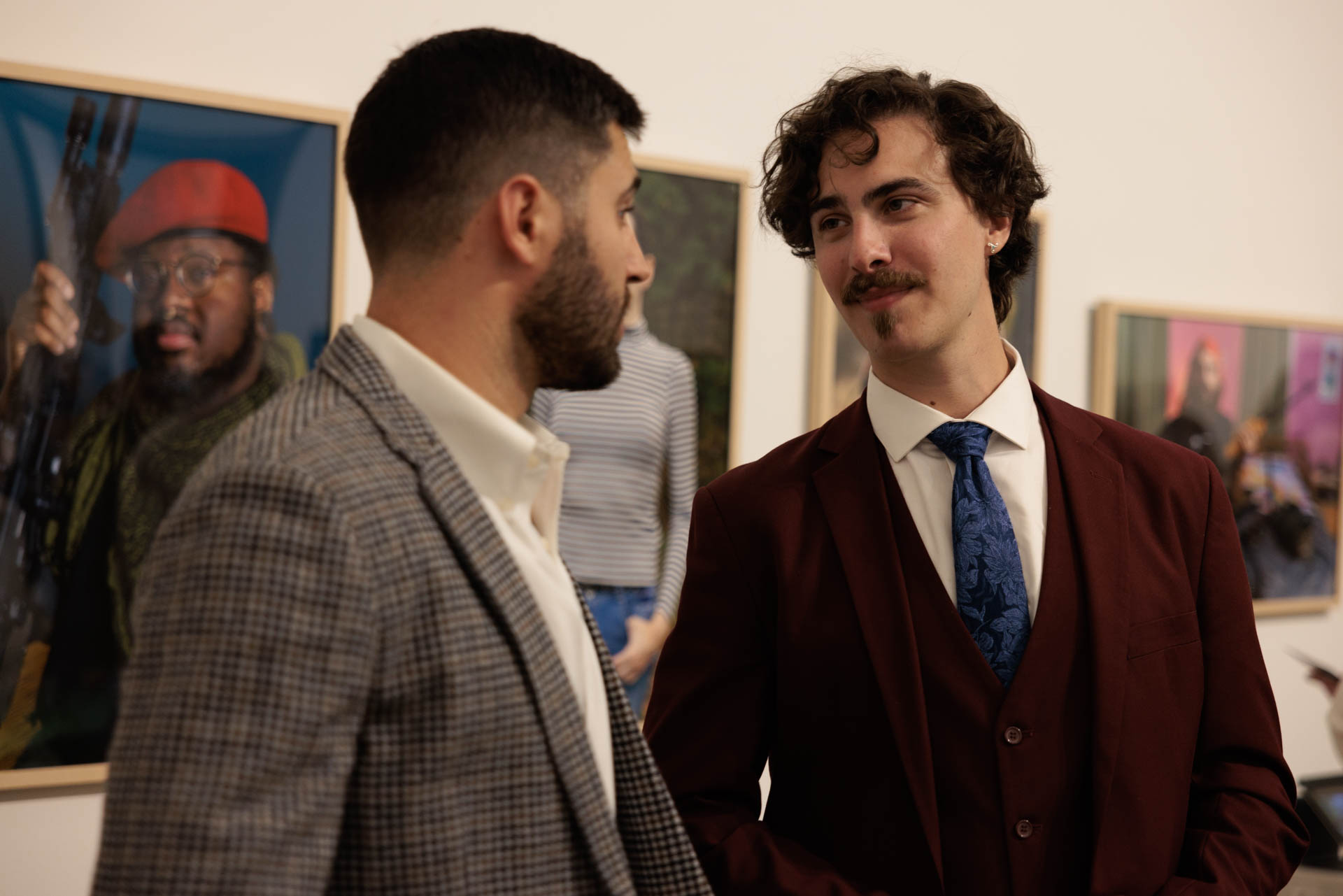 Two men at a photo exhibit at NEXT