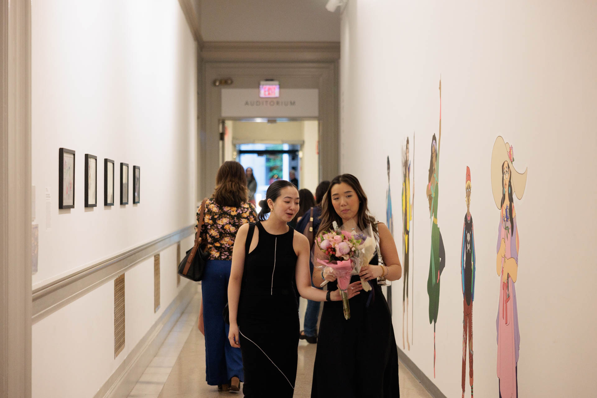 Women walk in a hall at the Flagg Building