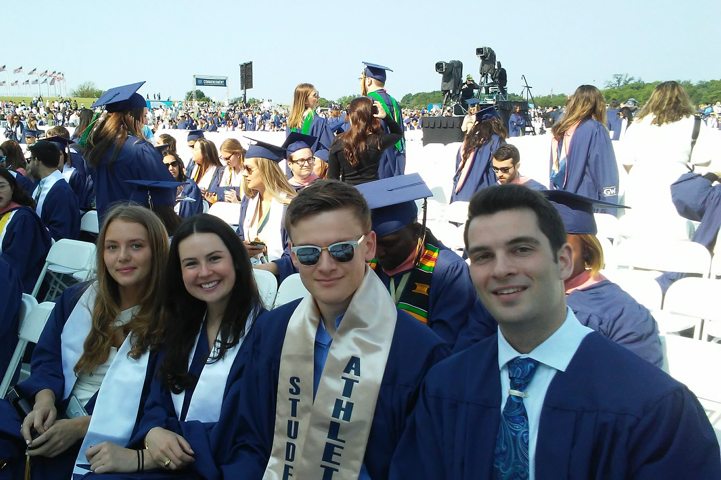 Four GW graduates at Commencement on the National Mall