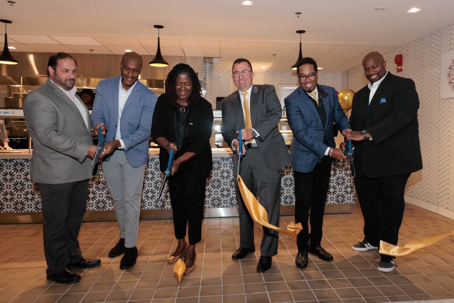 Six members of the GW community cut a ribbon to open Chaat House