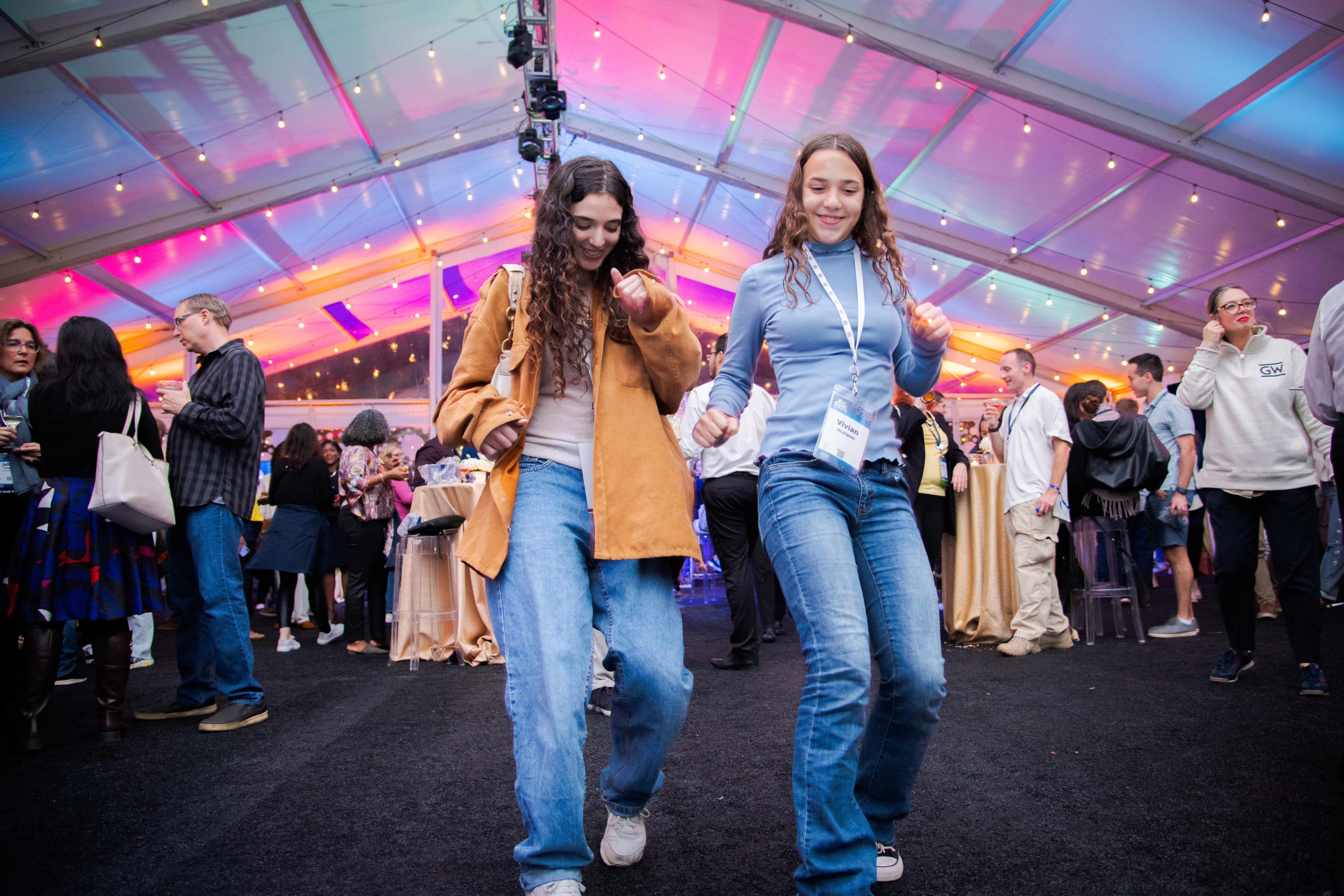 Two women dancing in a tent