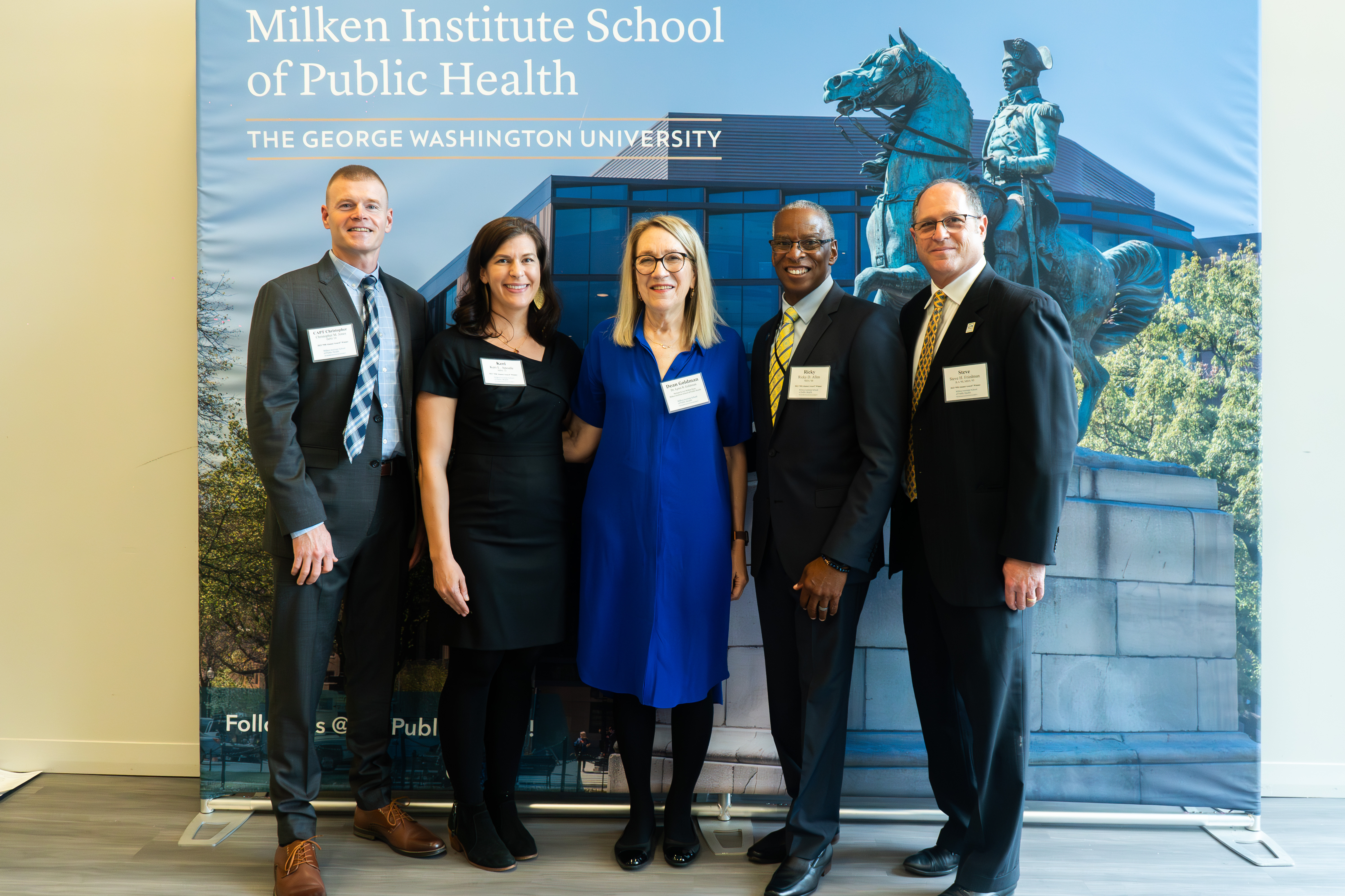 Dean Lynn R. Goldman is flanked by four alumni awardees: Christopher Jones and Keri Apostle are at left, and Ricky D. Allen and Steve Friedman are at right