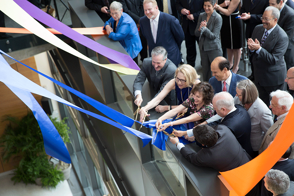 Michael Milken (right, center rear) at the dedication of the Milken Institute School of Public Health building. 