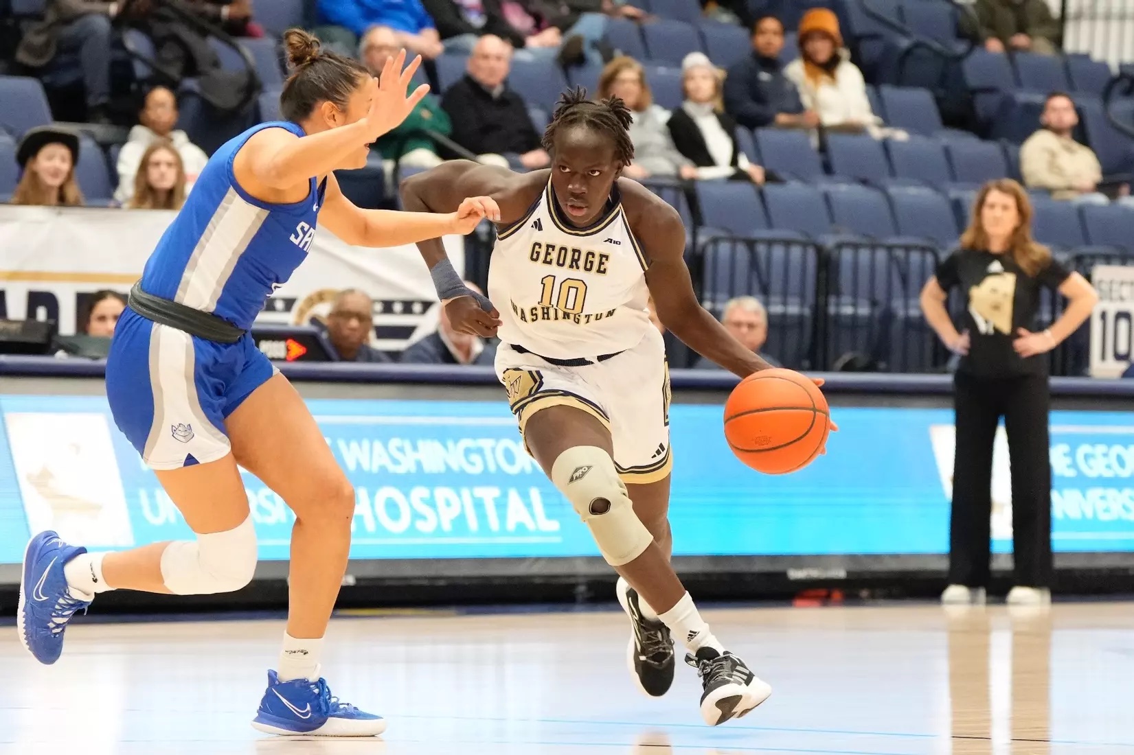 Nya Lok drives basketball