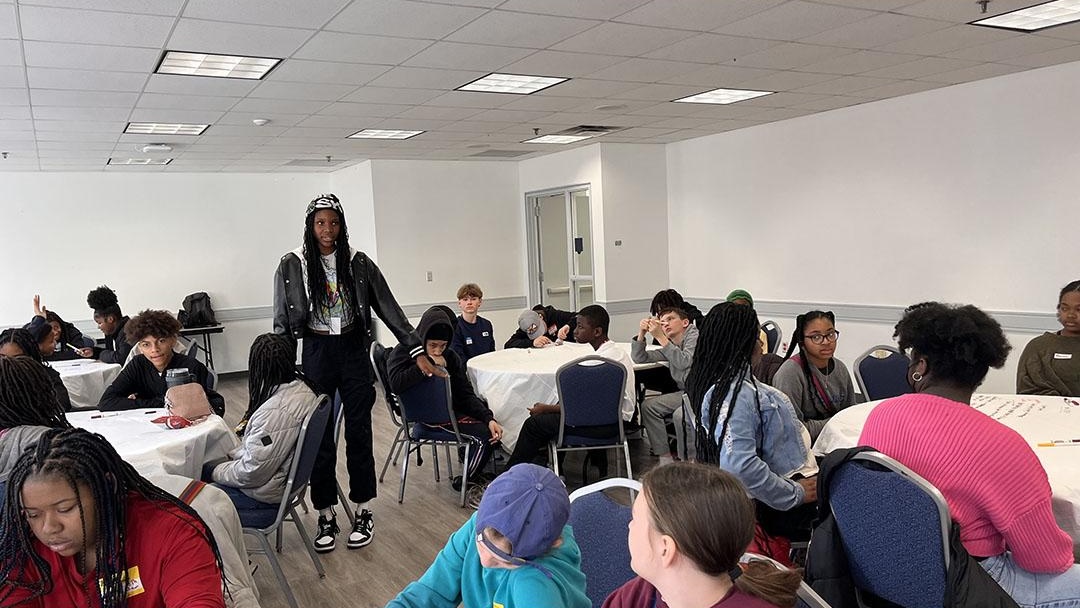 Eliot-Hine Middle School Model United Nations President Maliyah Williams poses questions to the larger group.