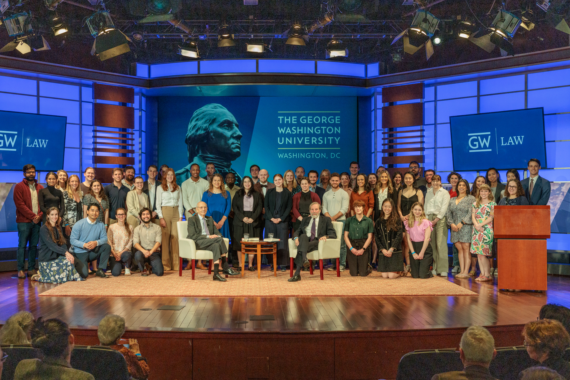 GW Law students crowd the stage in Jacob Burns Auditorium where Alan Morrison and Justice Stephen Breyer sat