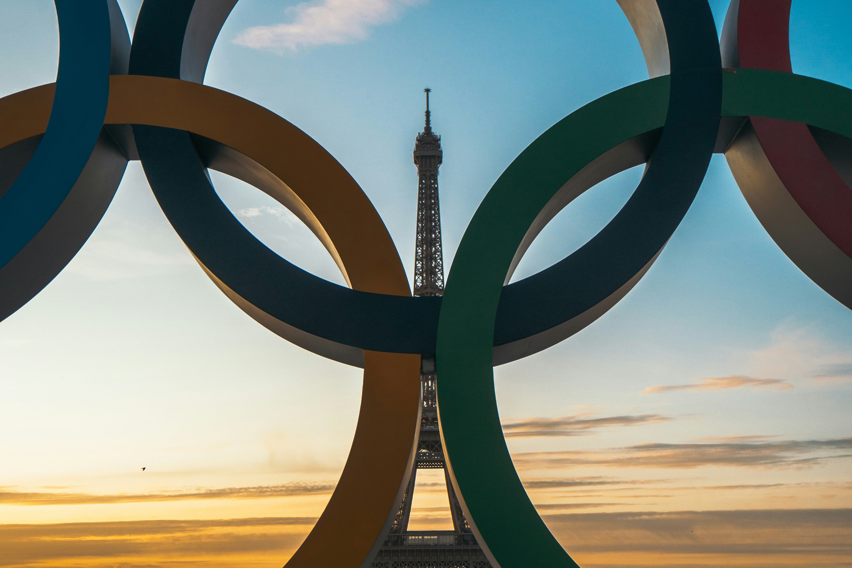 The Olympic rings in front of the eiffel tower. 
