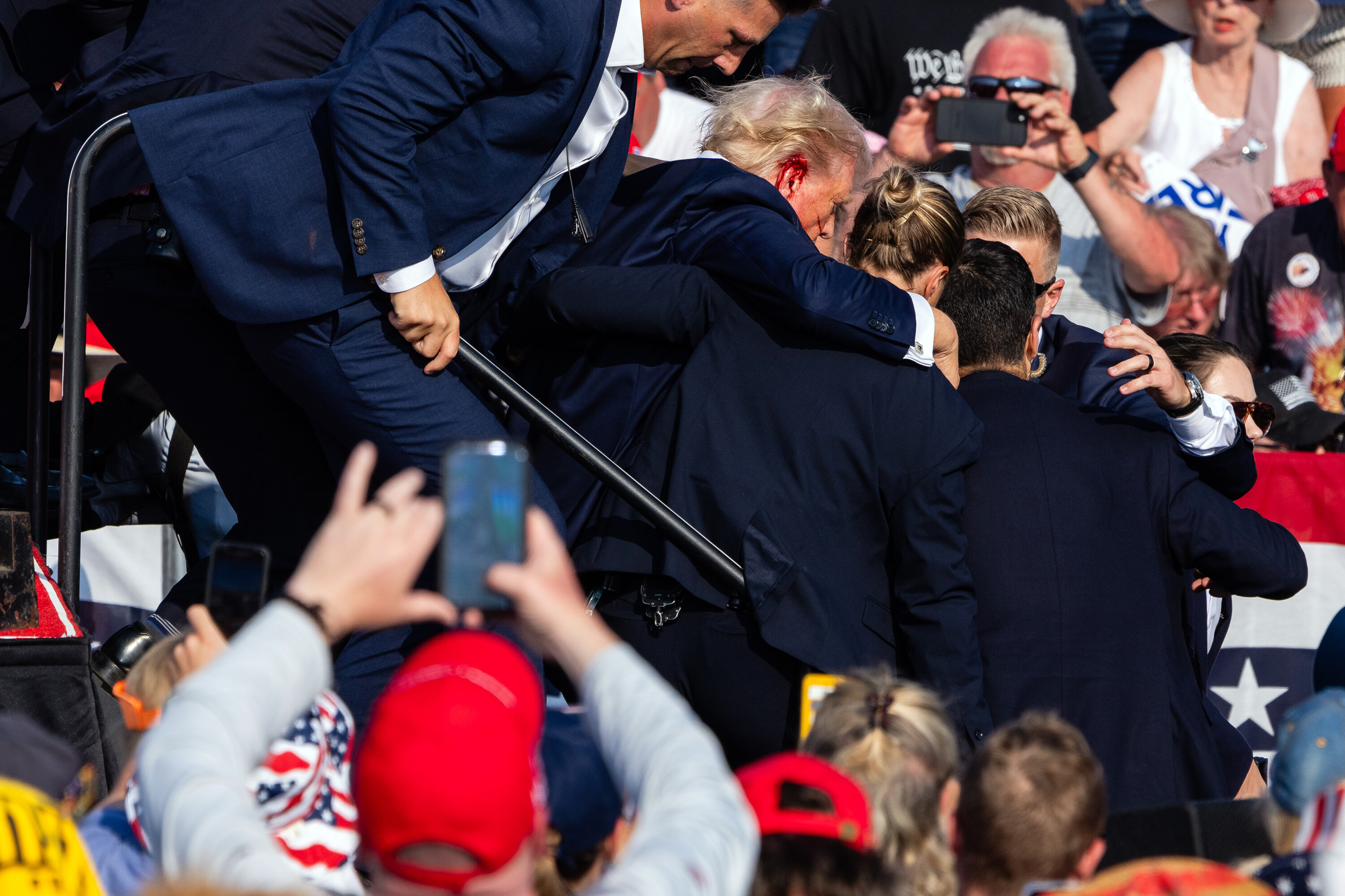 Donald Trump leaving stage after getting shot