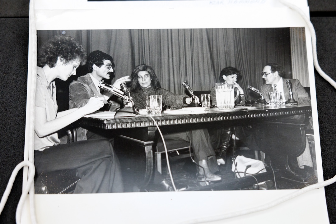 A black and white photo of a group of 5 people sitting at a panelist table