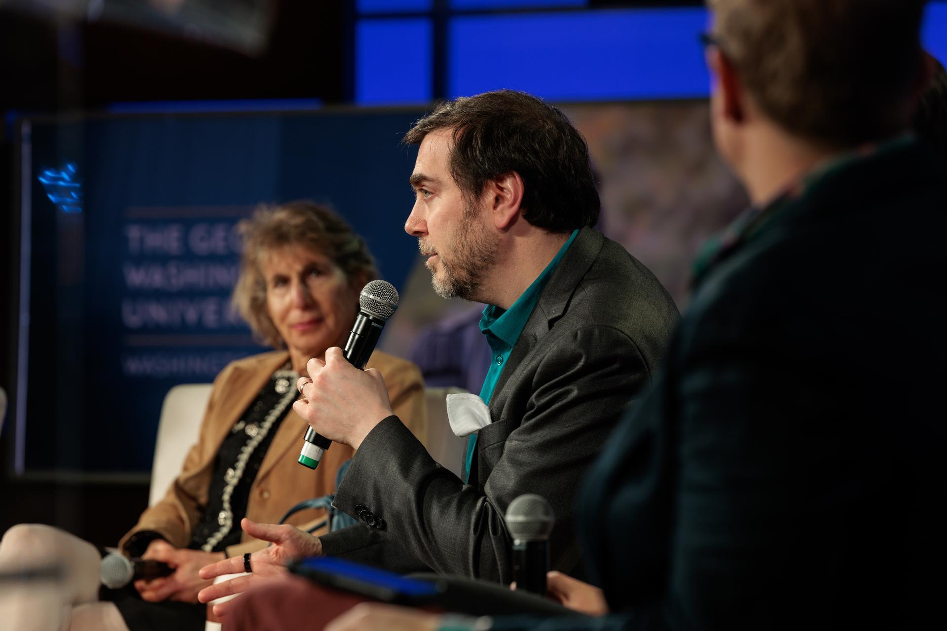 David Broniatowski speaks at the conference's closing panel, as fellow panelist Susan Ariel Aaronson looks on. (William Atkins/GW Today)