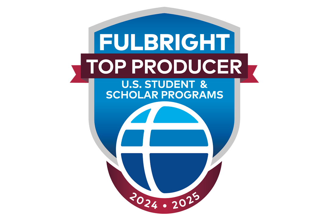 The logo for Fulbright Top Producers. Blue shield with blue globe.