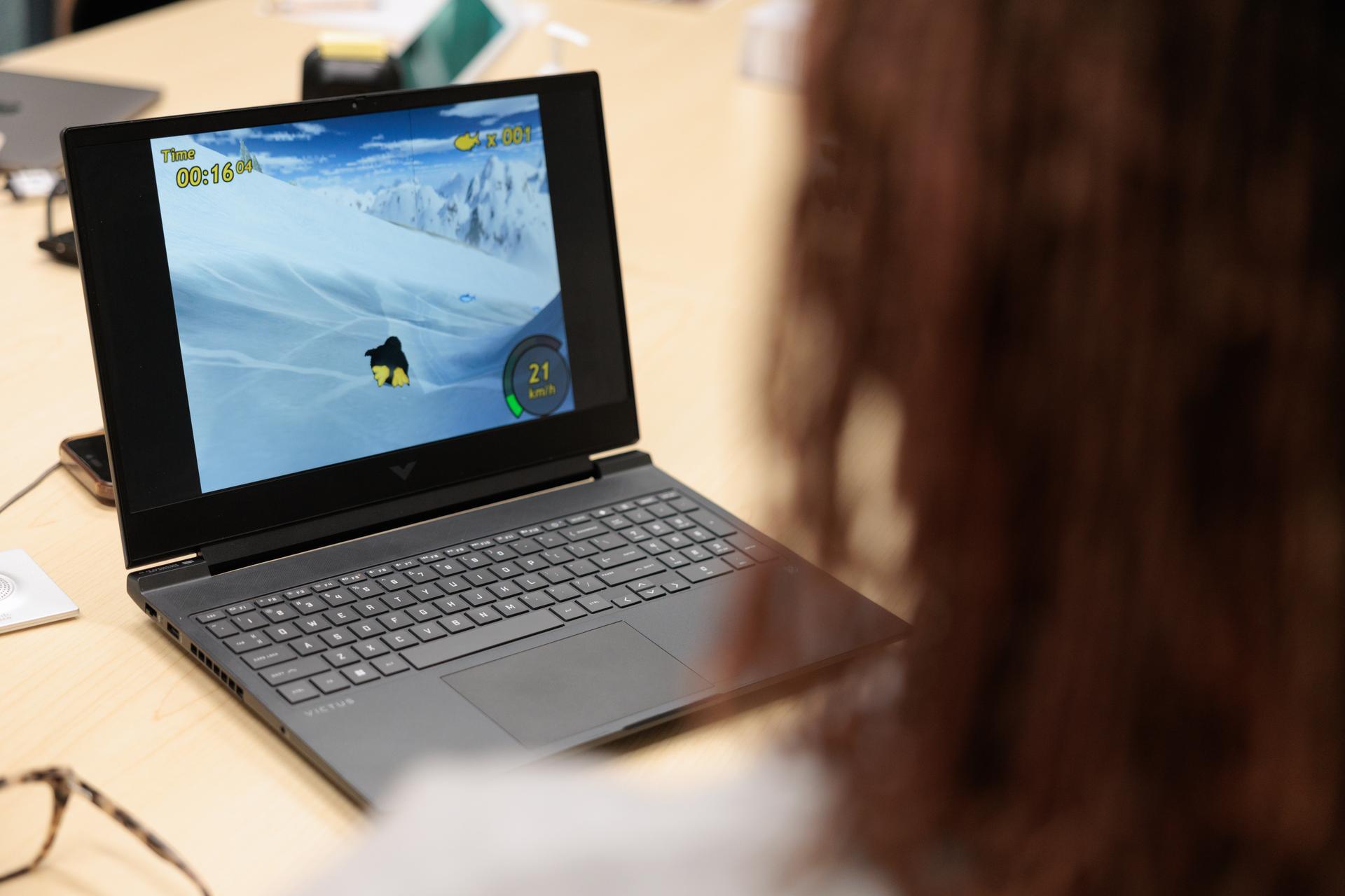 A player uses an EEG headset to control a penguin-racing game. 