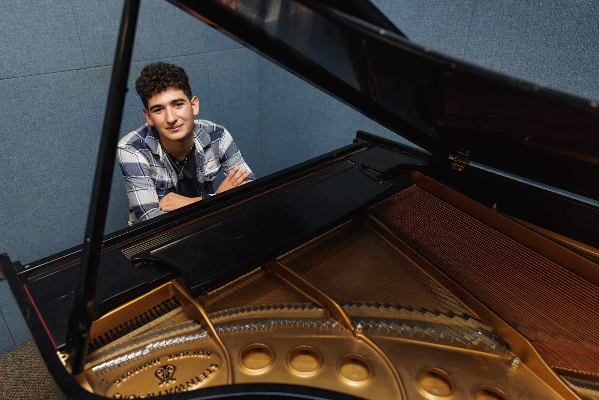 Zach Gindi-Chiafullo sits at the piano keyboard