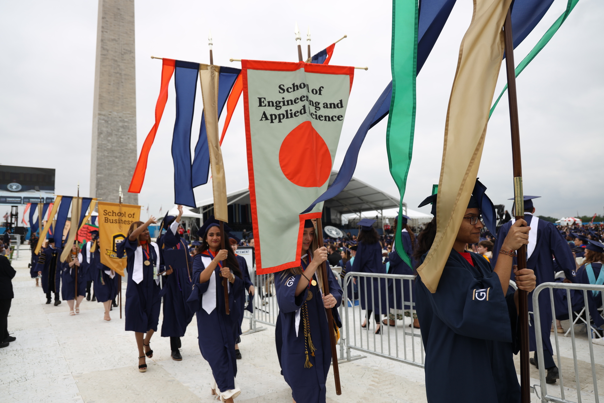 A graduate carries the SEAS flag at 2024 Commencement A graduate carries the SEAS flag at 2024 Commencement