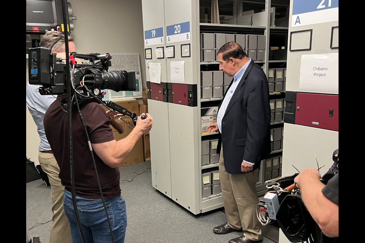 During filming for the documentary, Lou Chibbaro is shown with boxes of his materials in the GW Library stacks During filming for the documentary, Lou Chibbaro is shown with boxes of his materials in the GW Library stacks