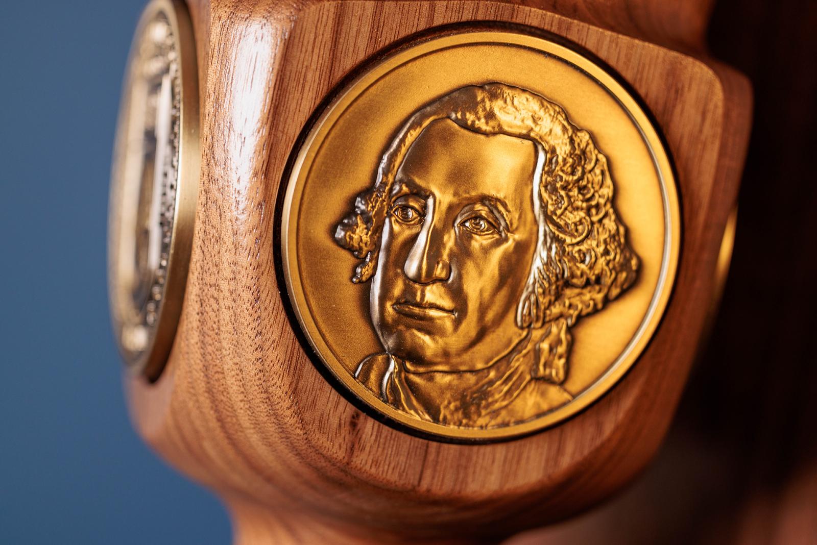 A close-up view of a detail on the university mace showing Washington's head A close-up view of a detail on the university mace showing Washington's head