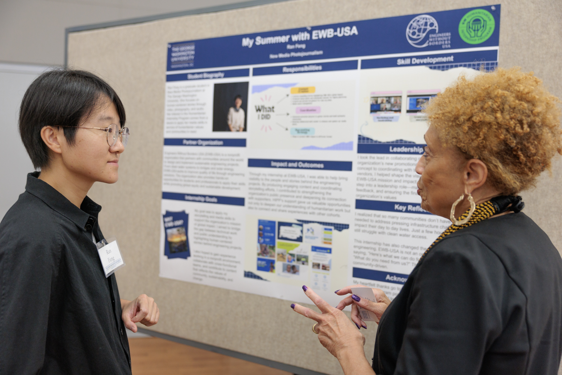 Student Ran Feng discusses her social media internship with a visitor