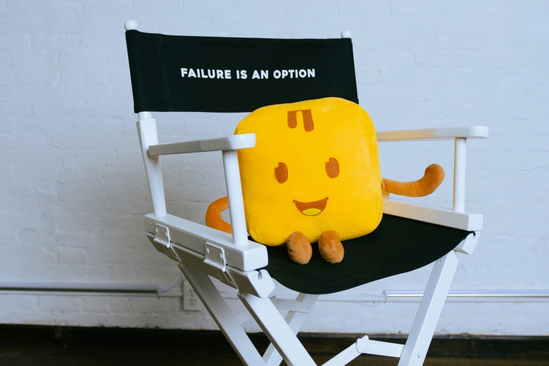 Givebutter mascot on chair