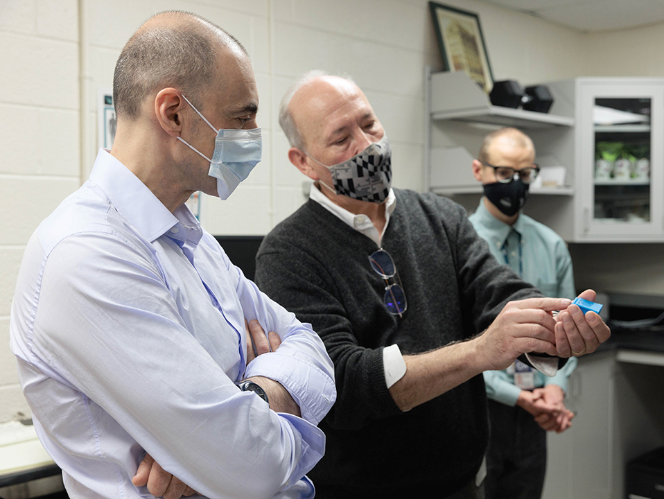 Dr. Tiim McCaffrey shows Ulvi M. Kasimov new diagnostic technology