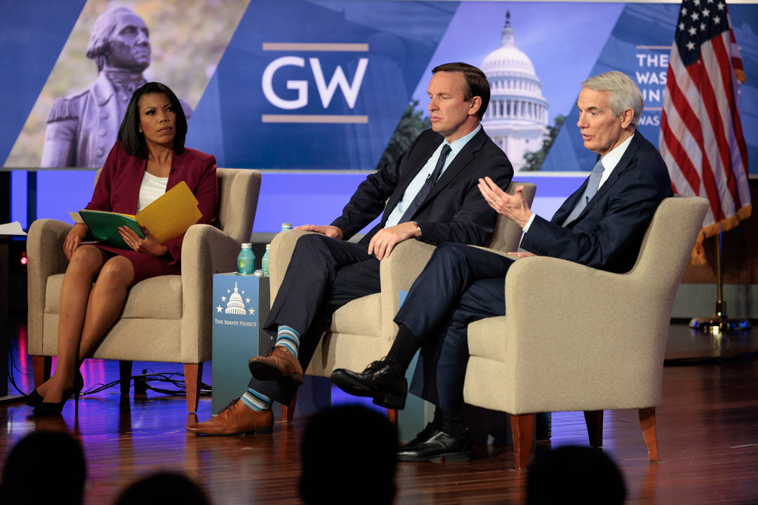 Three people talking on stage 