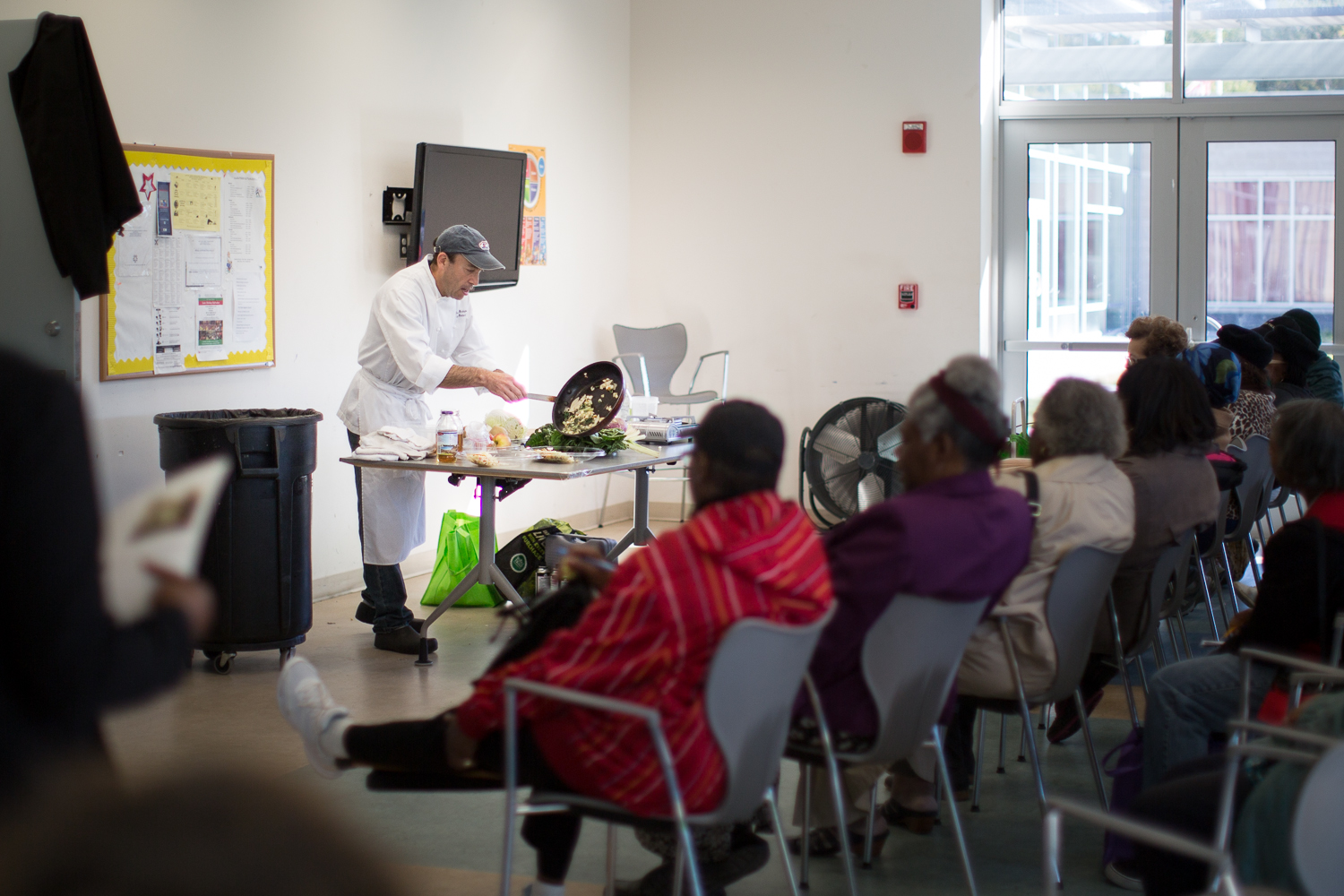 Residents of the community learn about ways to use the produce provided at the market.