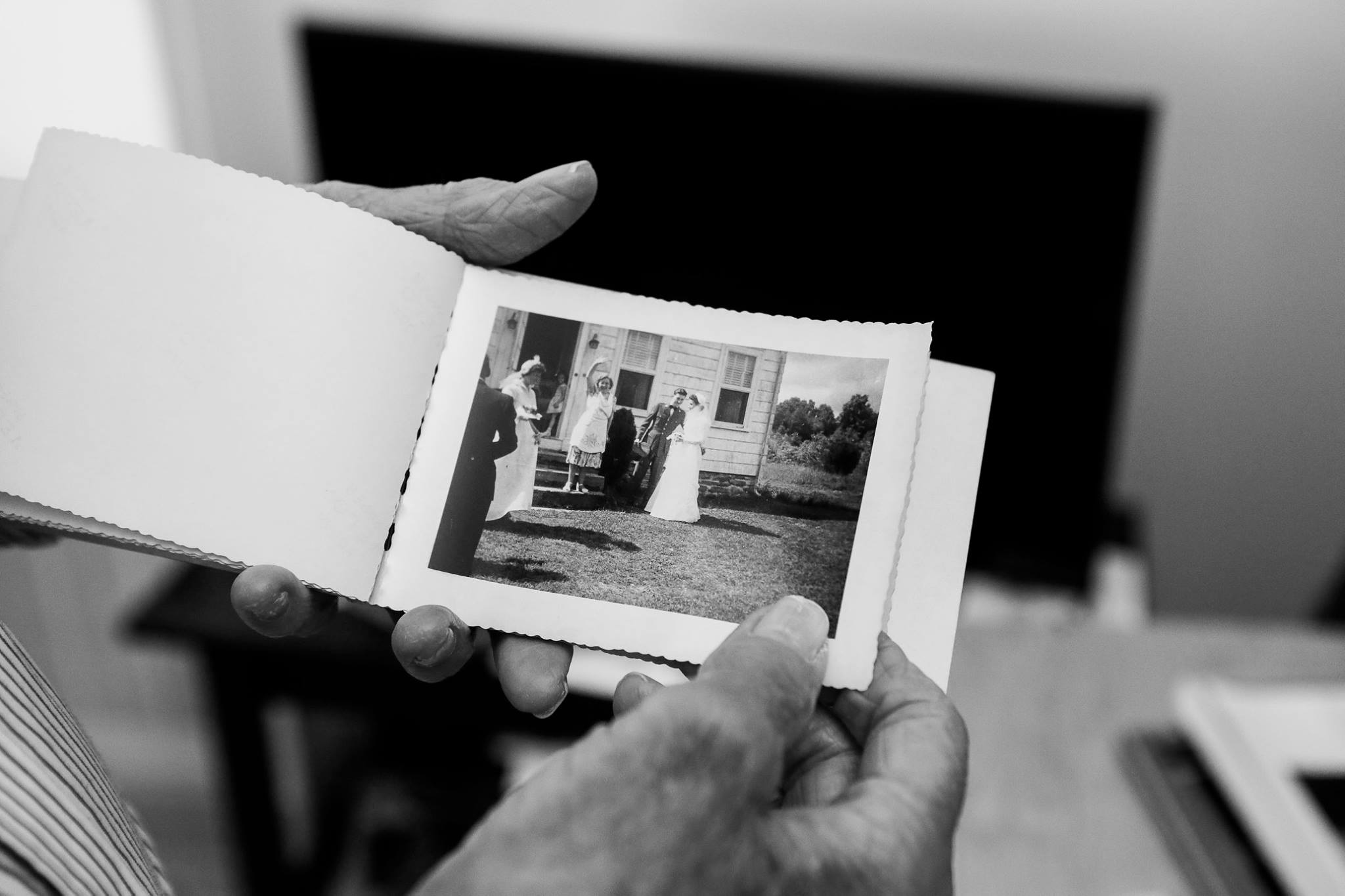 Mr. Lawrence displaying a photograph of his first wife