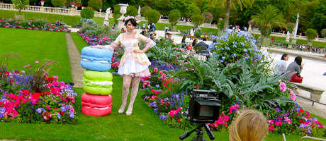 Anya Firestone stands in garden wearing colorful dress 