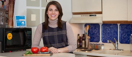 Audrey Scagnelli stands at kitchen counter smiling 