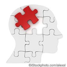 graphical representation of a head shaped by puzzle pieces and one of the top puzzle pieces at the top back of the head is red