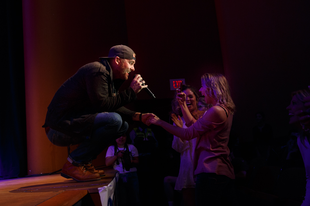 Brett Young holding hand of audience member singing