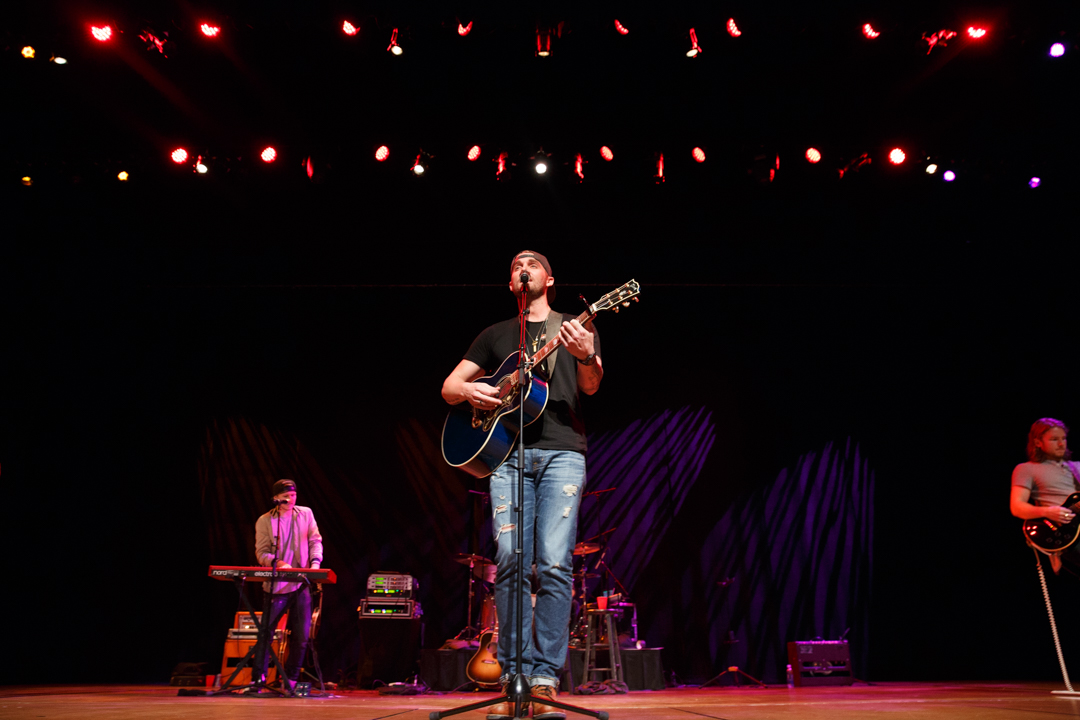 Brett young at mic playing guitar