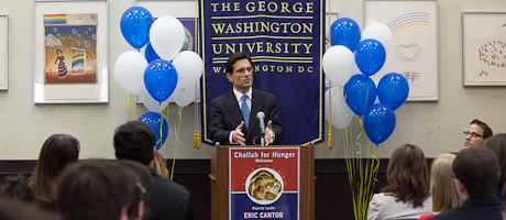 Eric Cantor speaks at podium with blue and white balloons behind him