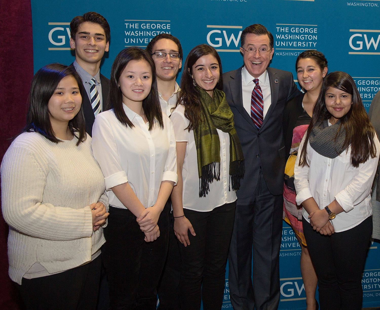 Students pose with Stephen Colbert behind the curtain at Lisner.