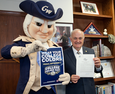 mascot George stands with Steven Knapp holding college colors day proclamation 