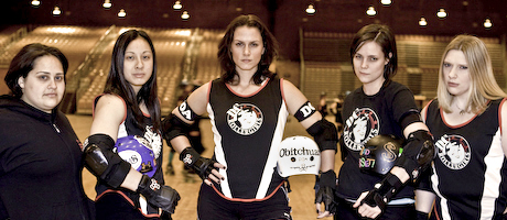 DC Roller Girls stand as a group in uniforms